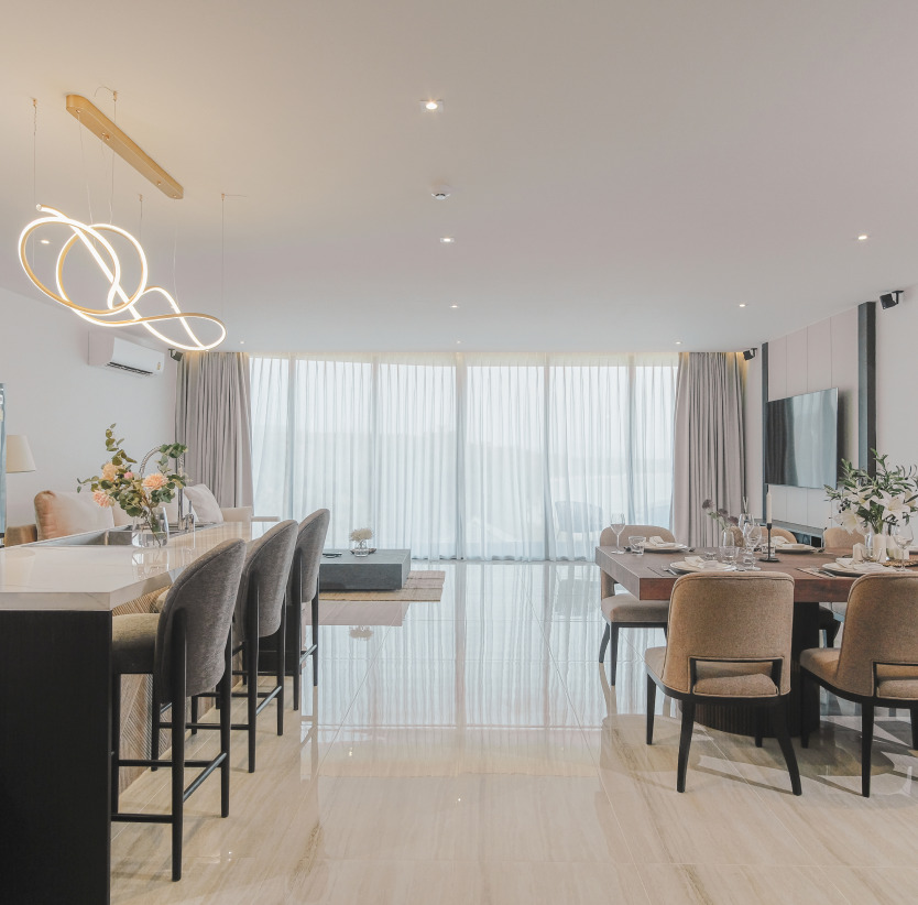 Indoor fully-equipped kitchen and formal dining table next to spacious living area