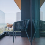 Outdoor balcony seating area overlooking Chalong bay