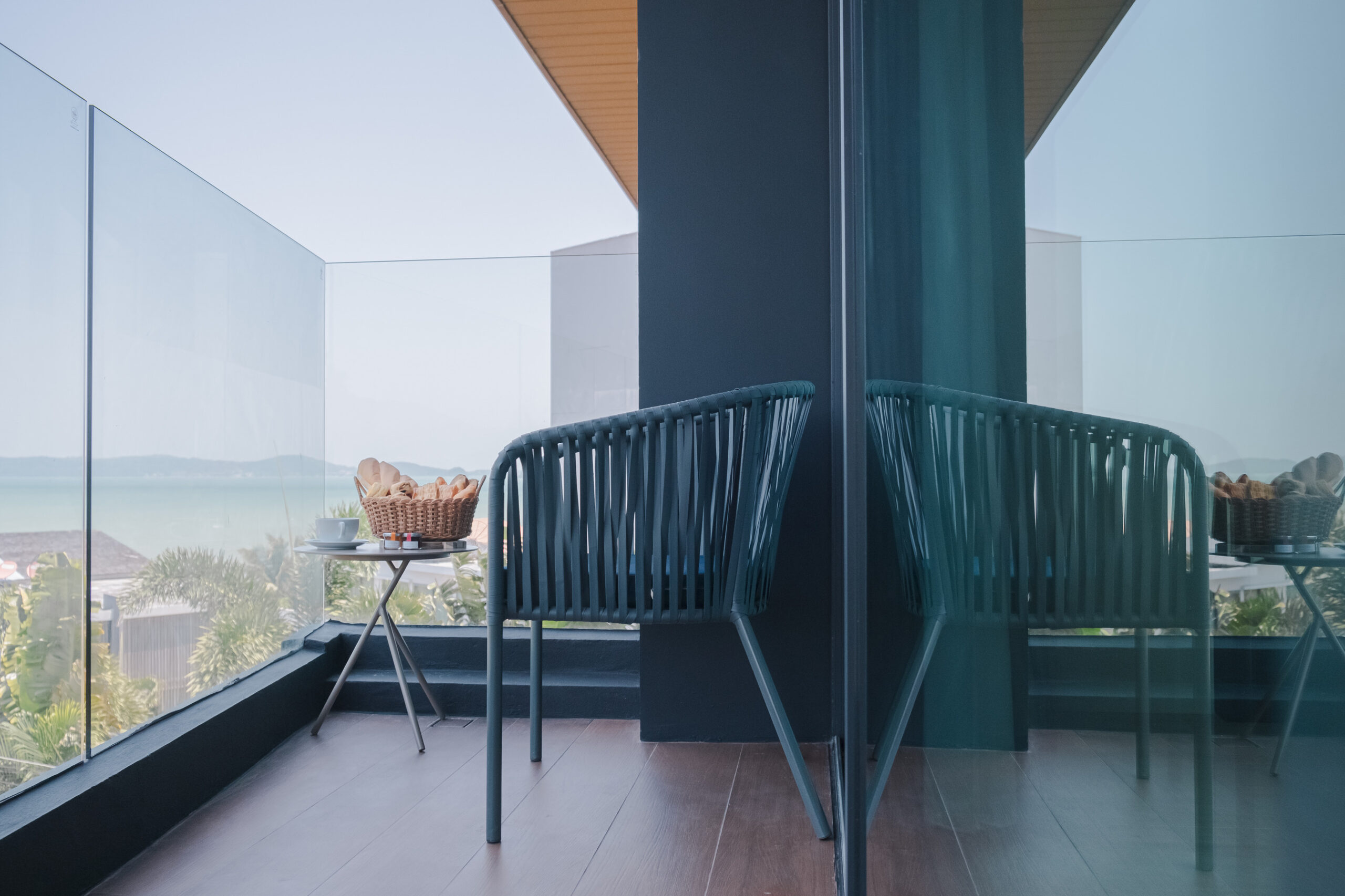 Outdoor balcony seating area overlooking Chalong bay