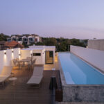 Rooftop terrace evening view with infinity swimming pool and outdoor lounge area