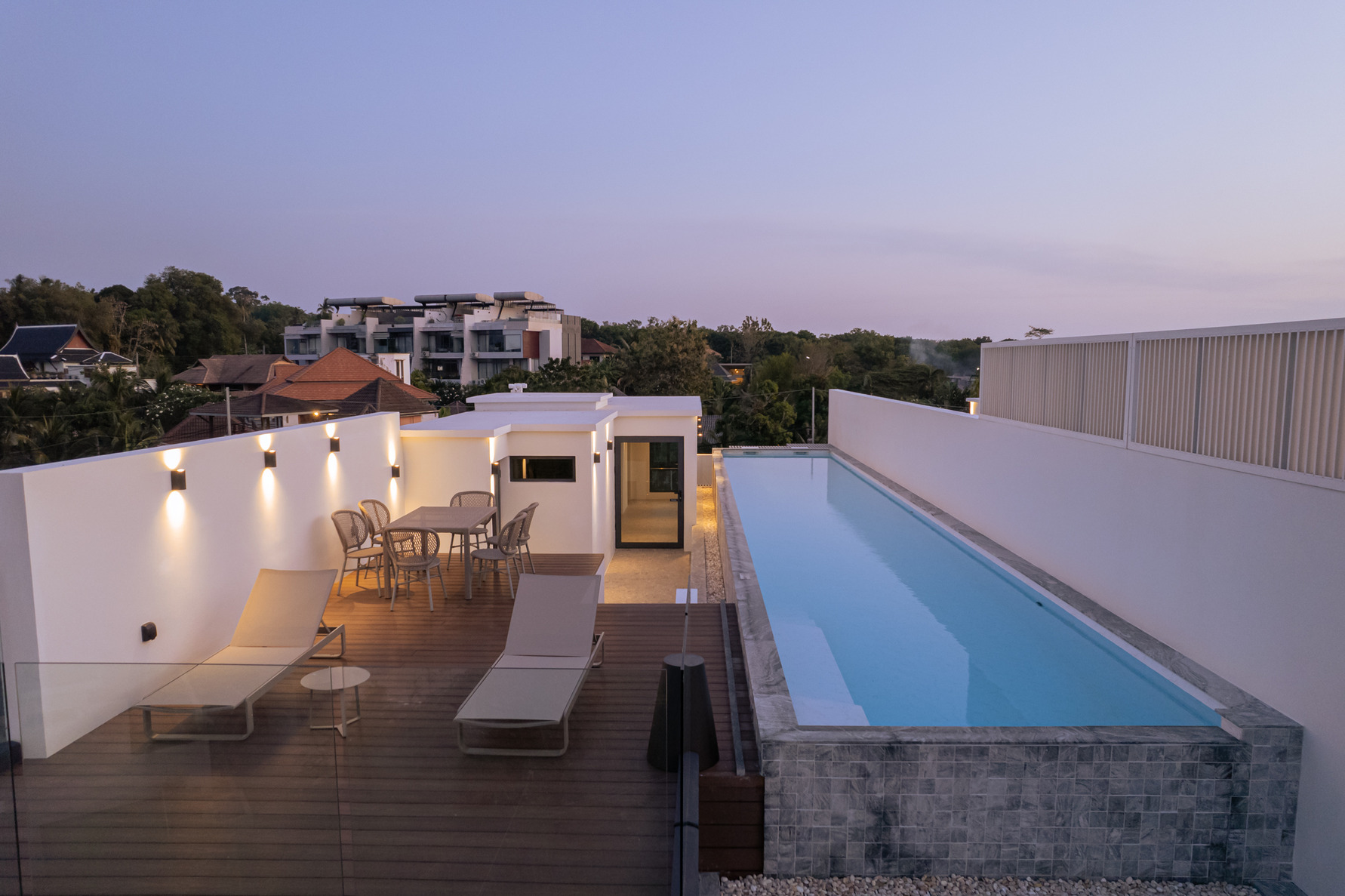 Rooftop terrace evening view with infinity swimming pool and outdoor lounge area